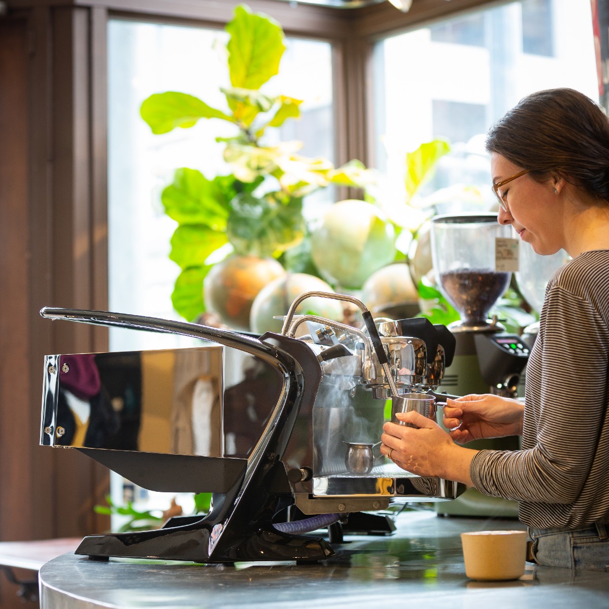 A barista makes coffee on the Slayer Steam LP espresso machine.